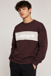  Adidas Burgundy Crew Neck Sweatshirt featuring a stylish cream logo chest panel. Premium men's casual sweatshirt with a comfortable fit, perfect for everyday wear and streetwear fashion.