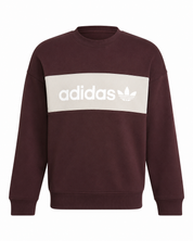  Adidas Burgundy Crew Neck Sweatshirt featuring a stylish cream logo chest panel. Premium men's casual sweatshirt with a comfortable fit, perfect for everyday wear and streetwear fashion.
