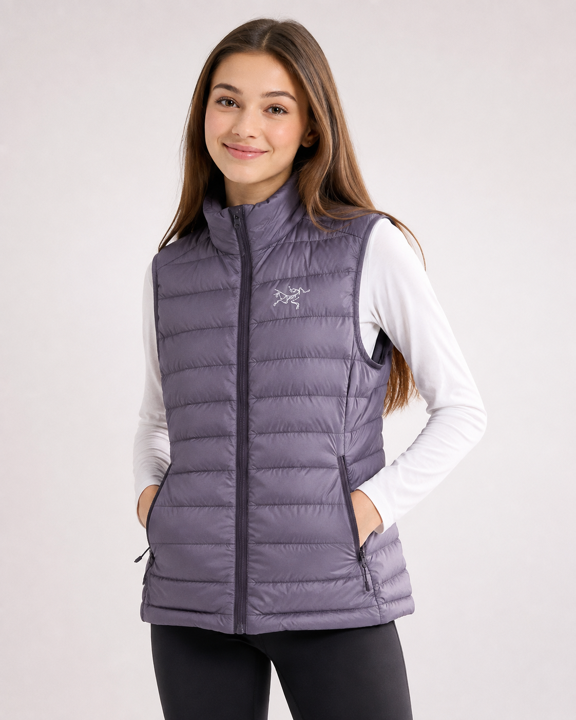   Arc'teryx Girls' Quilted Puffer Vest in lavender purple. Warm, lightweight and stylish with zipped pockets. UK size 12–14 years.
