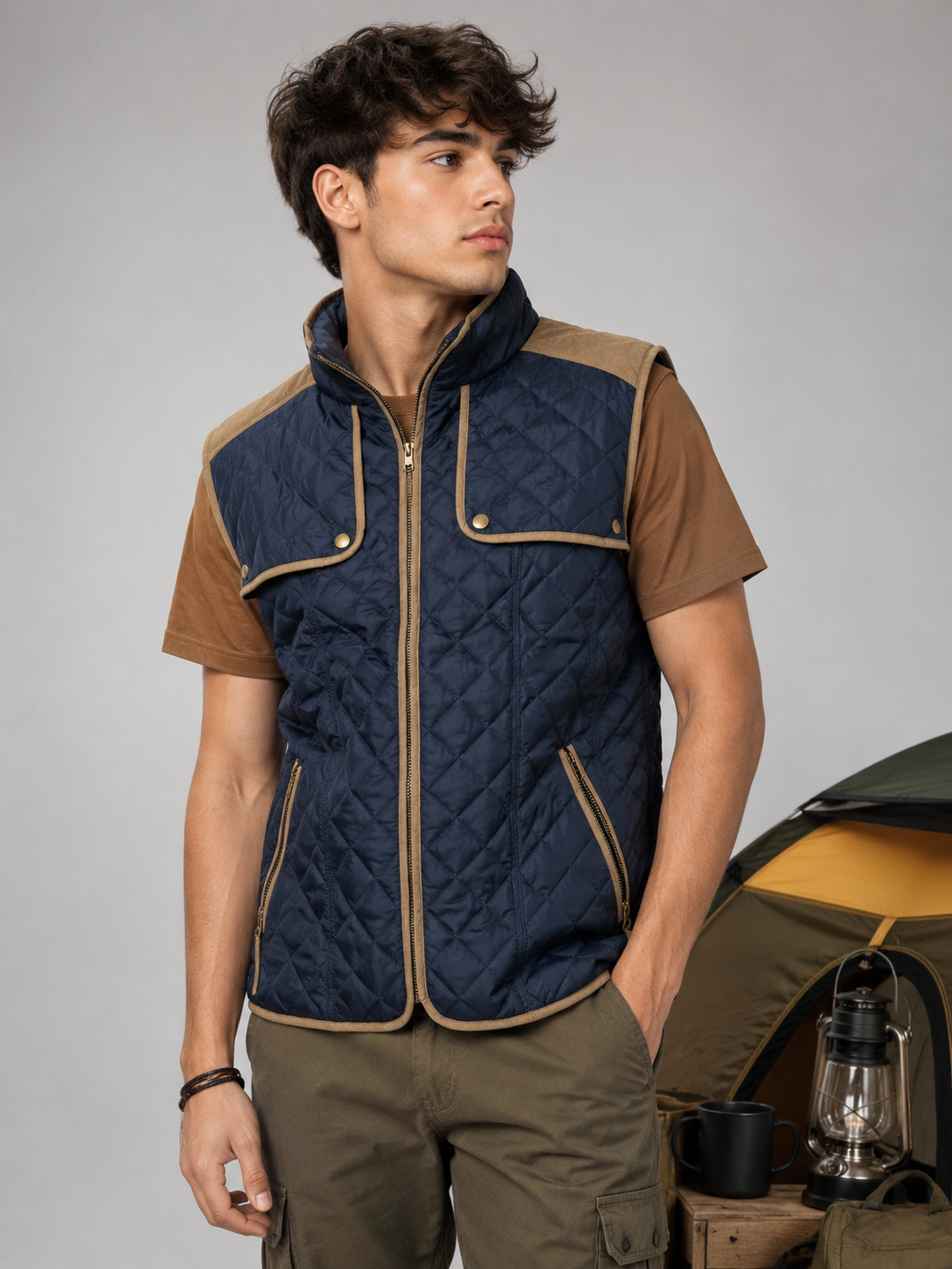  Atmosphere men’s navy blue quilted gilet in UK size M, featuring tan trim, multiple pockets and a stylish outdoor camper-inspired design.