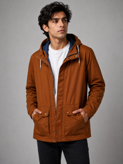  Craghoppers men’s rust brown hooded outdoor jacket, UK size L. Features practical pockets, zip fastening and versatile outdoor styling.