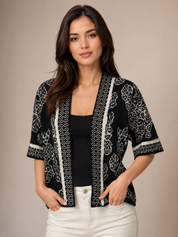 Eyida Made in Italy women’s black and white floral knit cardigan. Stylish short-sleeve open-front design with elegant patterned detailing.