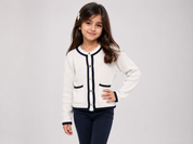 F&F Girls Cream Ribbed Knit Cardigan in UK Size S, featuring navy trim, gold-tone buttons and front pockets. Stylish and versatile for everyday wear.