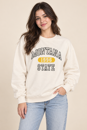  this F&F Montana State 1996 cream sweatshirt in UK size S. A comfortable women’s varsity-style crew neck jumper with a bold graphic print.