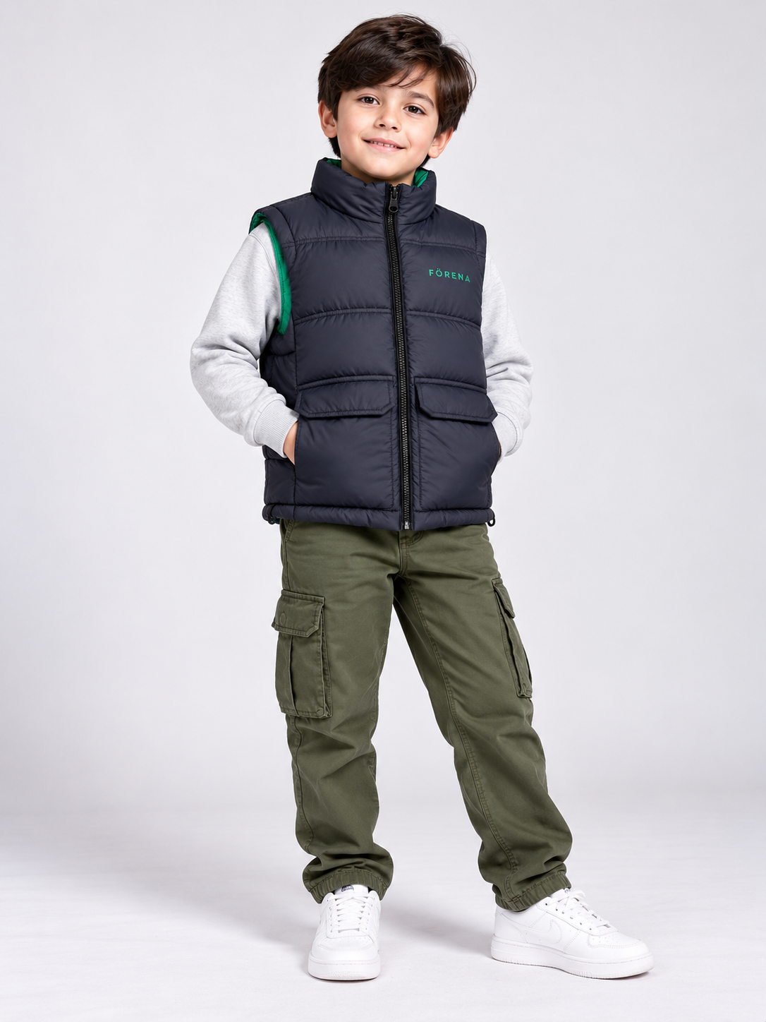 FORENA Boys Navy Blue Quilted Puffer Gilet, UK 8–9 Years. Features green lining, zip fastening, flap pockets and a stylish sleeveless design.