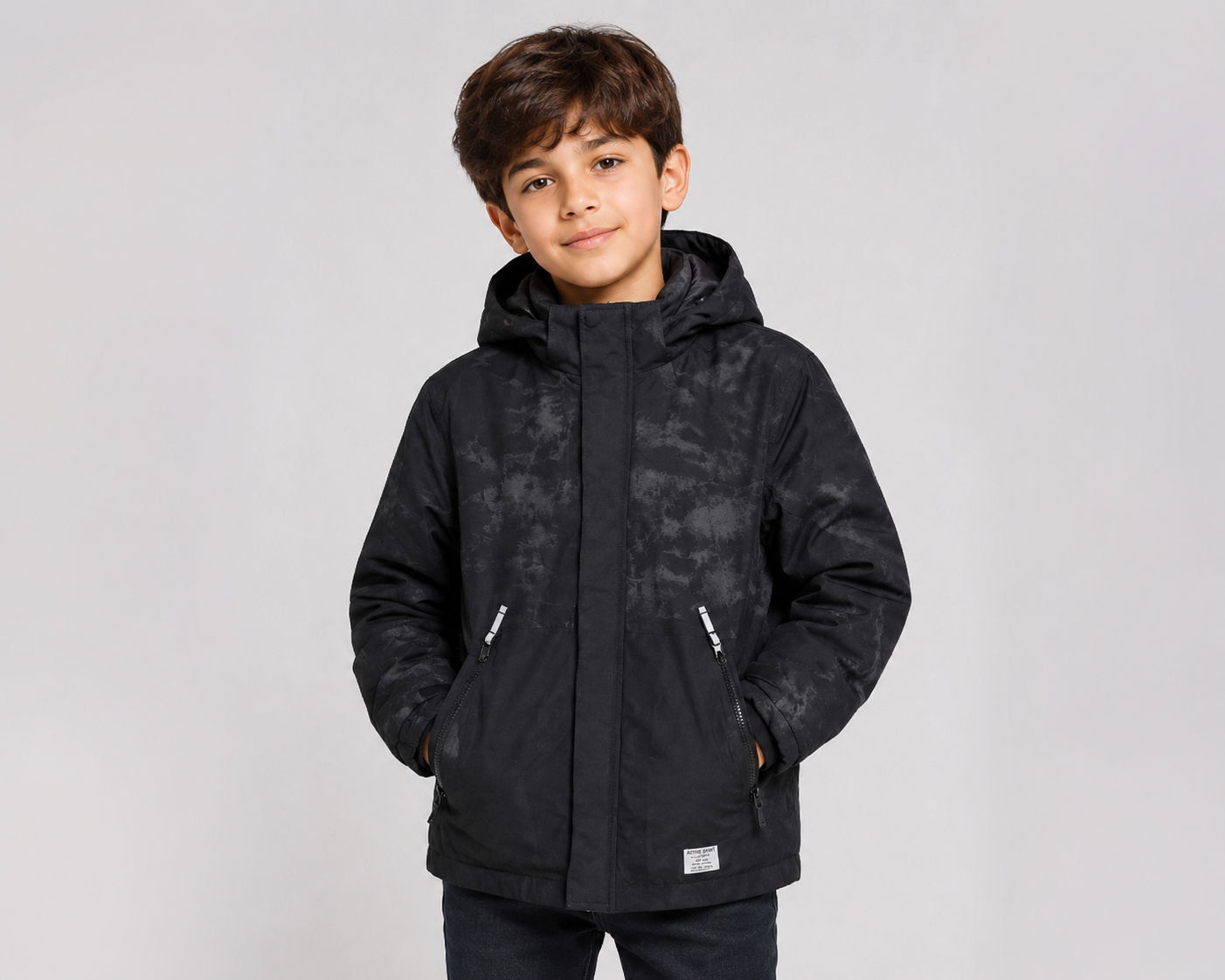  H&M Kids Black Hooded Winter Jacket featuring a warm insulated design, hood, zip pockets, and a stylish black camouflage pattern. Perfect for boys during autumn and winter.