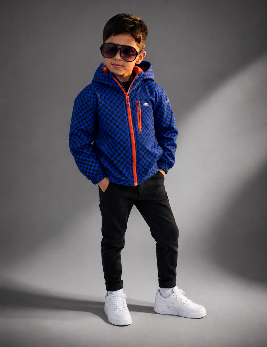 Kids Trespass Blue Checkered Hooded Jacket in UK Size 5–6 Years. Stylish kids' outdoor coat with hood, orange zippers and practical design.
