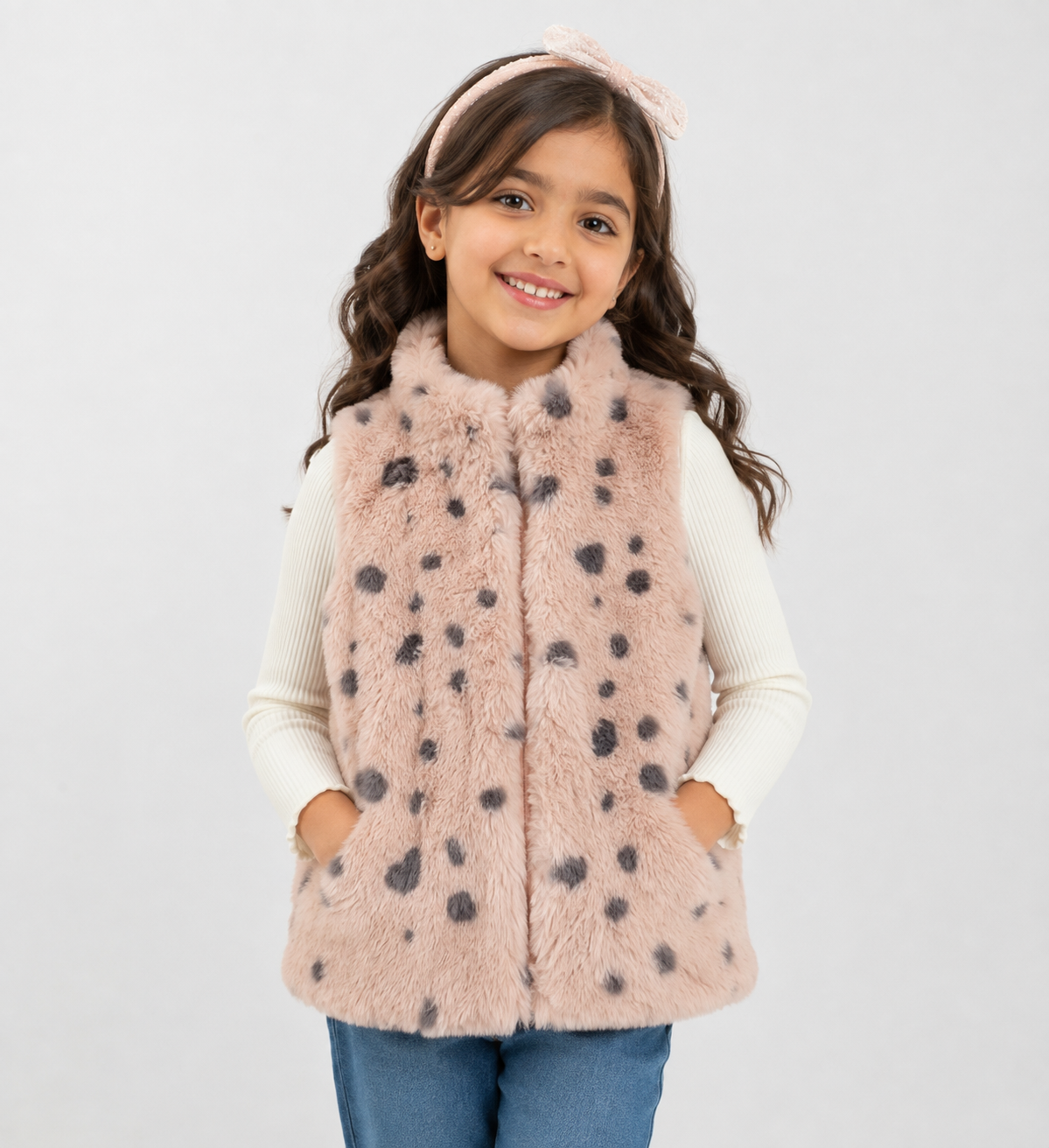 Little Kids girls' faux fur spotted gilet in soft pink with grey spots. Cosy sleeveless vest for girls, UK size 7-8 years, perfect for stylish winter layering.
