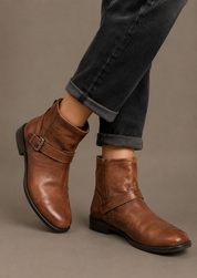  Lotus women’s brown ankle boots featuring a stylish buckle strap, rounded toe and durable low heel. A versatile choice for casual and everyday outfits.