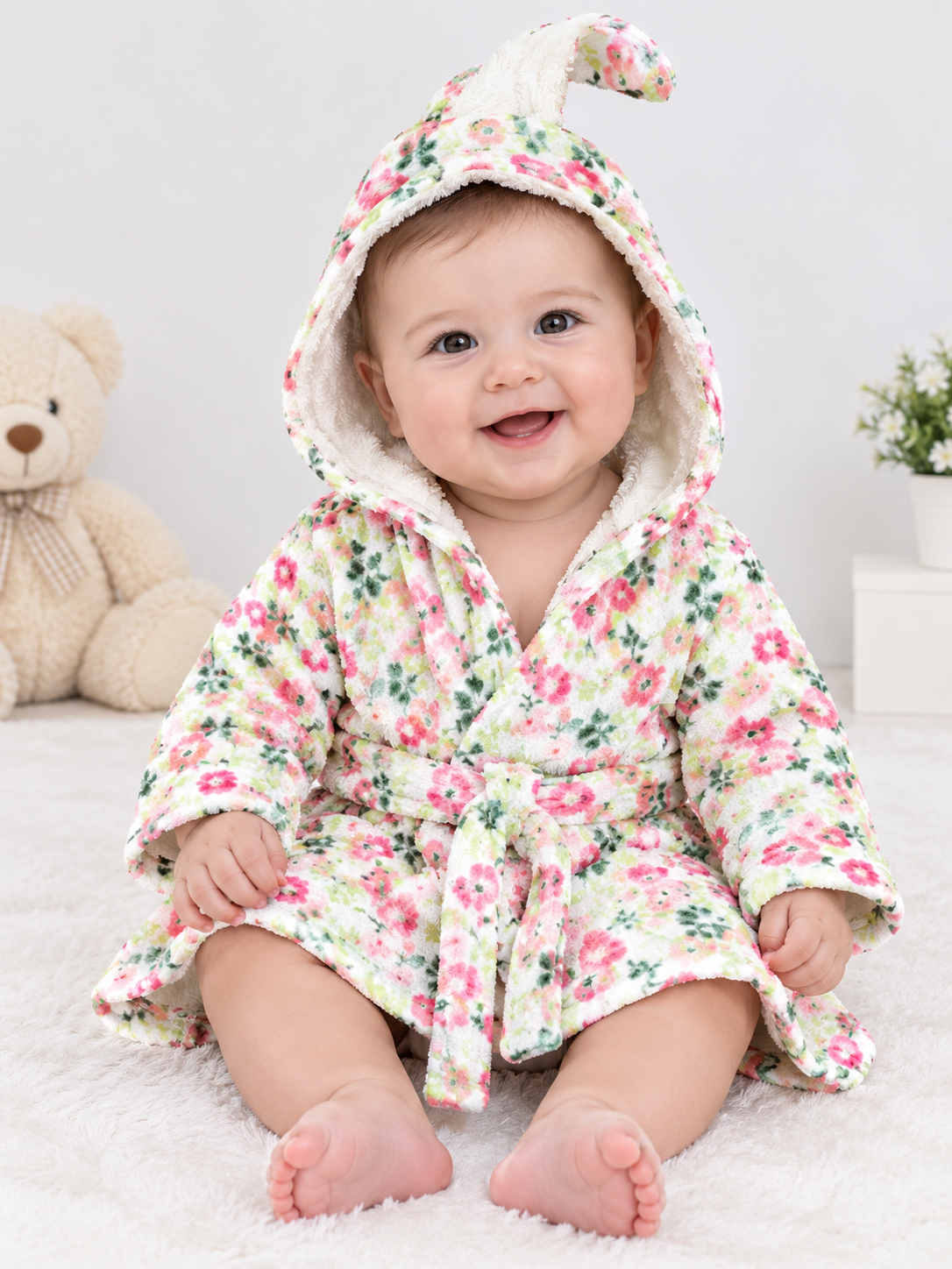 Modern Baby floral hooded dressing gown in UK 6 months. Soft plush baby bathrobe with cute hood, floral print and matching waist belt.