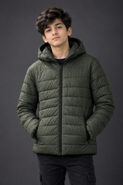   PRIMARK boys’ olive green hooded puffer jacket in UK 13/14 years, featuring quilted padding, zip pockets and a full front zip—perfect for everyday winter wear.