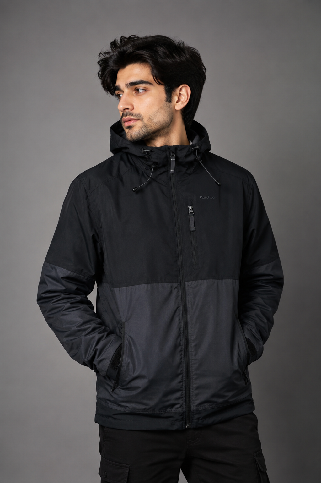  QUECHUA men’s hooded outdoor jacket in black and charcoal, UK size L. Features adjustable hood, zipped pockets and versatile outdoor styling.