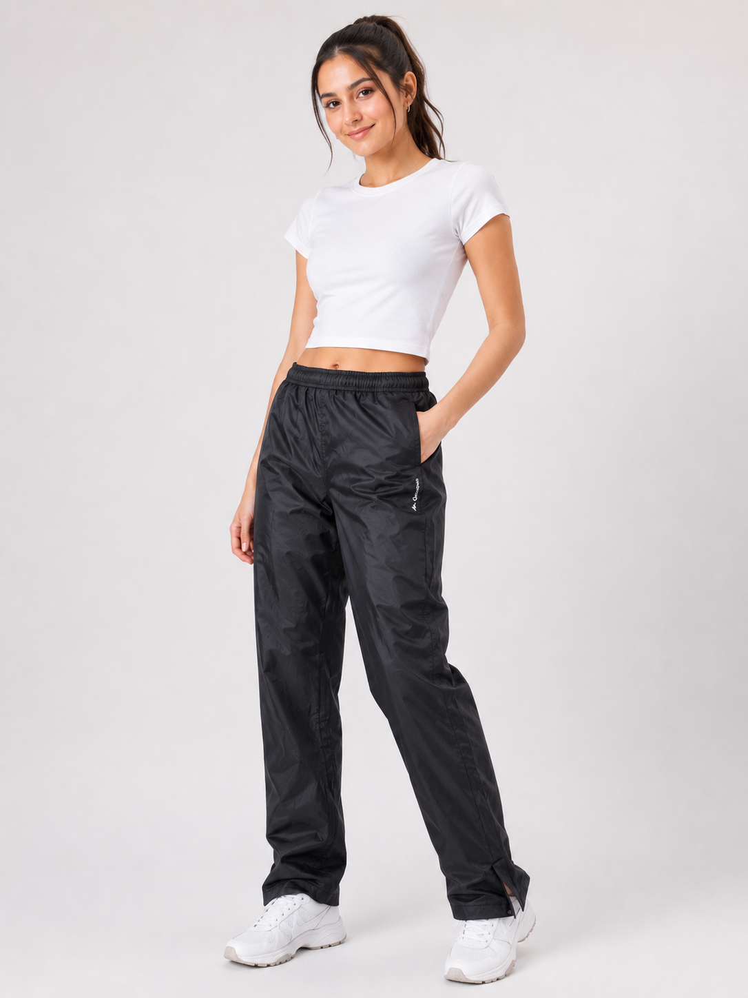  Quechua women’s black track pants in UK Size M. Lightweight outdoor trousers with elastic waist and practical pockets, ideal for sports and casual wear.