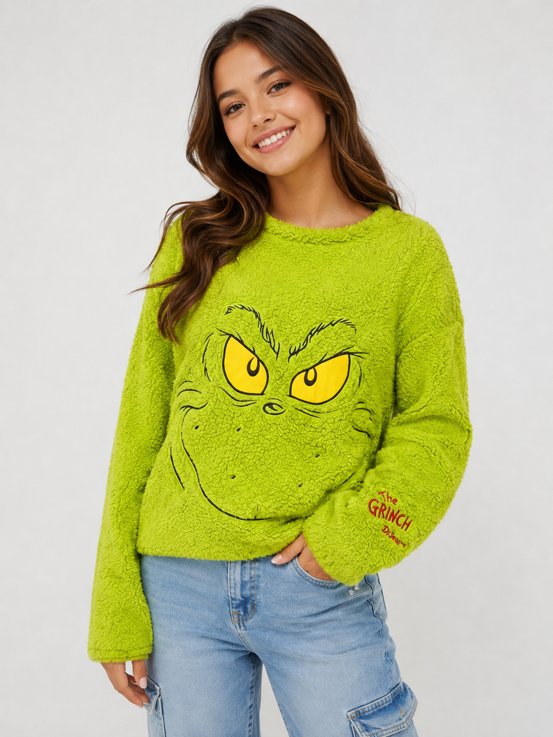  The Grinch neon green fleece sweatshirt in UK Size XL. Soft and cosy plush design featuring a fun Grinch face graphic, perfect for Christmas and winter wear.